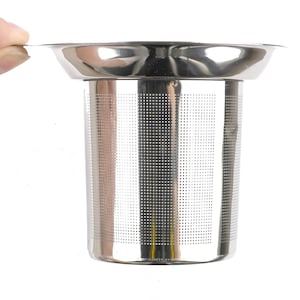 May include: A stainless steel tea infuser with a fine mesh filter. The infuser has a removable lid and a cylindrical shape.
