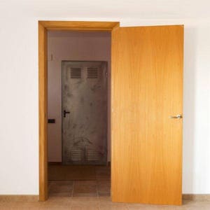 May include: A wooden door with a metal door behind it. Both doors have handles. The wooden door is light brown and the metal door is gray.