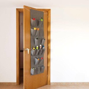 May include: A gray fabric over-the-door shoe organizer with 10 pockets. The organizer is hanging on a wooden door and is filled with various items, including shoes, cleaning supplies, and other household items.