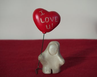 Handmade miniature love figurine with red heart I Love U balloon, handmade miniature love sculpture with I Love U on metallic red balloon