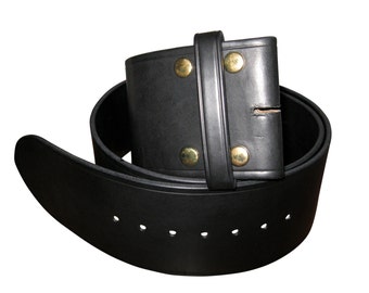 May include: A black leather belt with a rectangular buckle featuring four brass-colored rivets. The belt has multiple holes for adjustment and is designed for use with pants or trousers. The belt is made of a thick, durable leather.