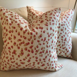 Ballard Designs “Mira” in spice and white pillow covers.