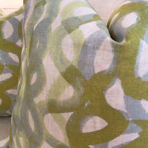 Christopher Farr in “Fathom” sage pillow covers