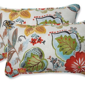 May include: Two rectangular throw pillows with a white background and a colorful floral pattern. The pattern features red, yellow, green, blue, and brown flowers and leaves.