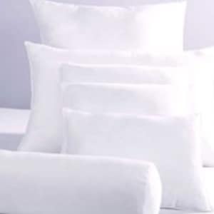 May include: A set of five white pillows of varying sizes. The pillows are arranged in a stack, with the largest pillow at the bottom and the smallest pillow at the top.