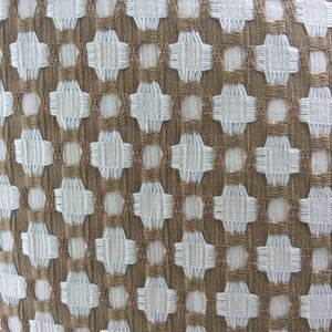 May include: A close-up of a woven fabric with a geometric pattern. The fabric is brown and white, and the pattern is made up of small squares and circles.