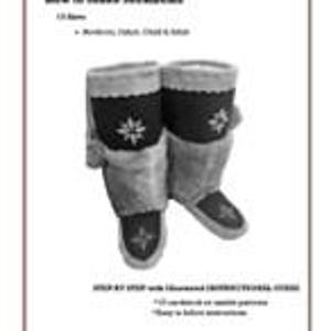 May include: A pair of black and grey winter boots with fur trim and a snowflake design. The boots are made of leather and have a traditional style.