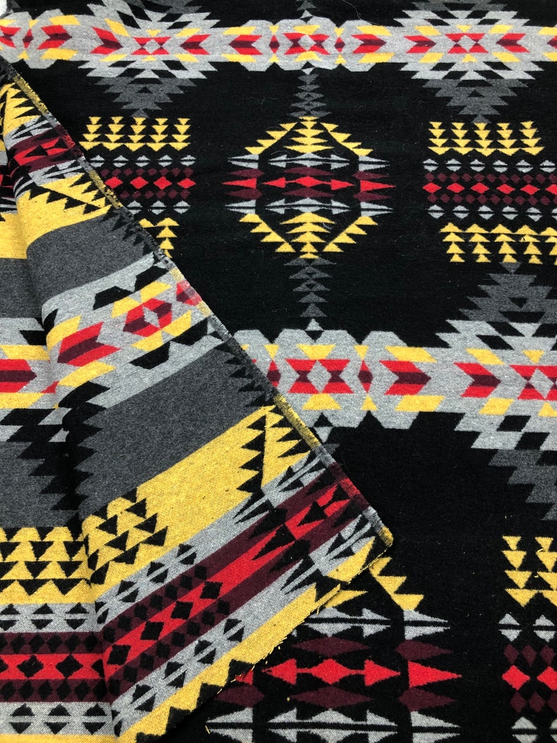 May include: Black and grey woven fabric with a geometric pattern in red, yellow, and white. The fabric has a traditional Native American design.