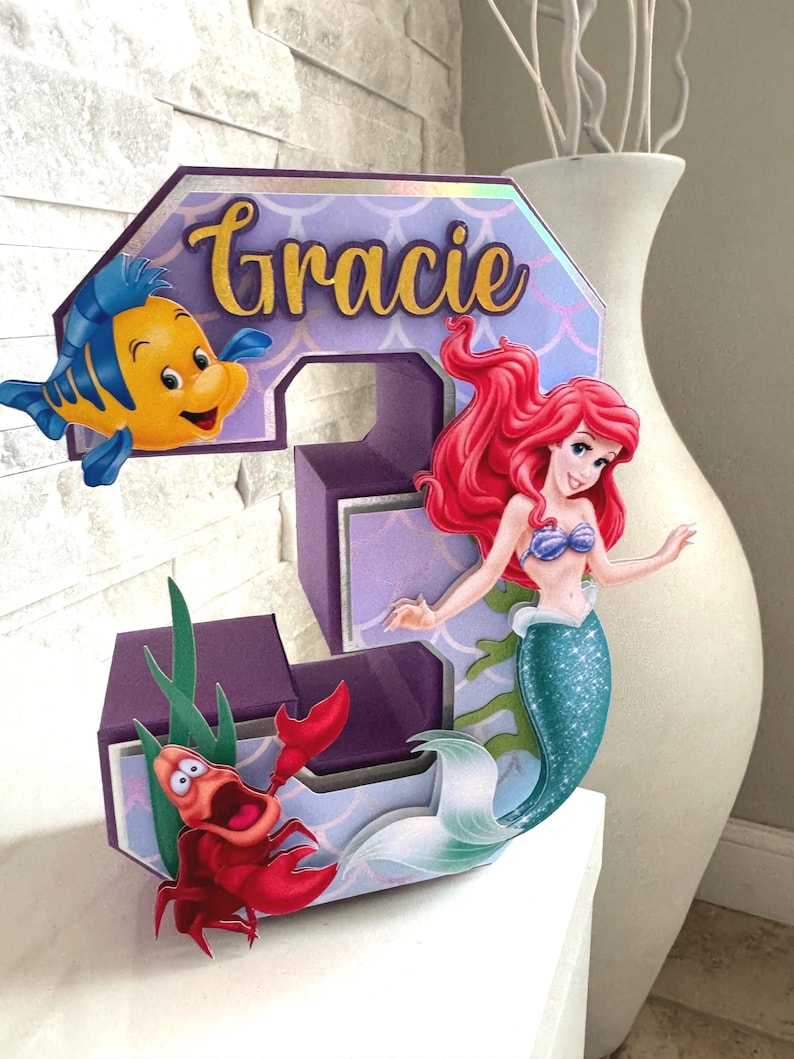 May include: A set of three ceramic nesting bowls in shades of blue, green, and white. The bowls feature a speckled glaze and a simple, modern design. The largest bowl measures approximately 6 inches in diameter.