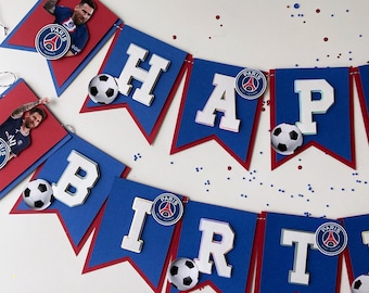May include: A blue and red banner with the word "Happy" and soccer balls. The banner also has the Paris Saint-Germain logo and the text "Paris".