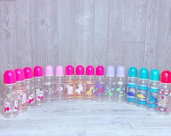 Vintage lot of 16 baby bottles angels , dinosaurs , bunny’s , bears sports