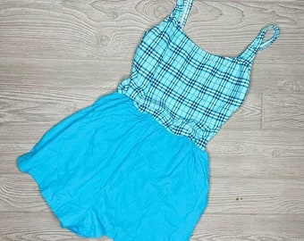 May include: A blue and white plaid sleeveless dress with a solid blue skirt.