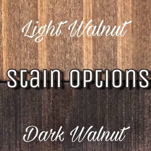 May include: Two wood samples showing different stain options. The top sample is a light walnut stain. The bottom sample is a dark walnut stain. The text "Stain Options" is printed between the two samples.