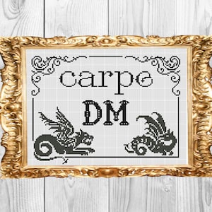 May include: A black and white cross-stitch design in a gold frame with the text "carpe DM" and two black dragons on either side of the text.