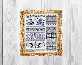 May include: A framed cross-stitch sampler with a white background and blue and black embroidery. The sampler features a variety of dragon designs and geometric patterns.