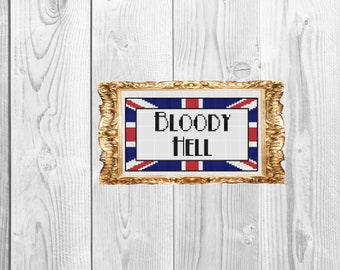 May include: A framed cross-stitch with a Union Jack flag background and the text "BLOODY HELL" in black letters.