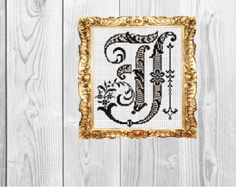 May include: A black and white cross-stitch embroidery of a decorative letter J in a gold frame. The letter is surrounded by intricate floral designs.