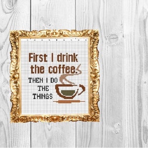 May include: A framed cross-stitch design with the text "First I drink the coffee. Then I do the things" and a stylized image of a coffee cup with steam.