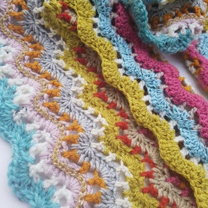 May include: Multicoloured crochet trim with a wavy pattern and gold thread accents.
