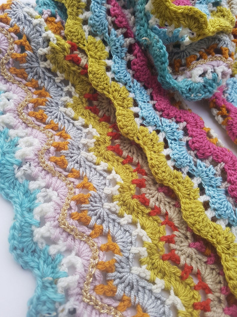 May include: Multicoloured crochet trim with a wavy pattern and gold thread accents.