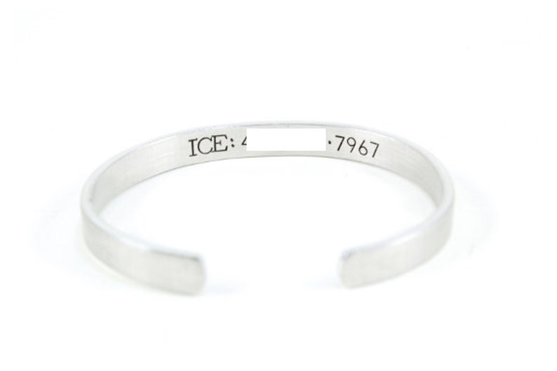 May include: Silver bangle bracelet with an inscription that reads "ICE: 4 .7967".