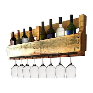 May include: A rustic wooden wine rack with a shelf for bottles and a rack for hanging wine glasses. The rack is made from reclaimed wood and has a natural, weathered finish.