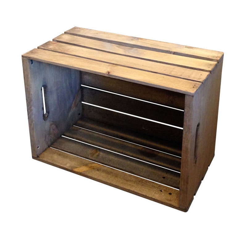 May include: A rustic wooden crate with a natural wood finish. The crate has a rectangular shape and is made of unfinished wood planks. The crate is empty and has a distressed look.