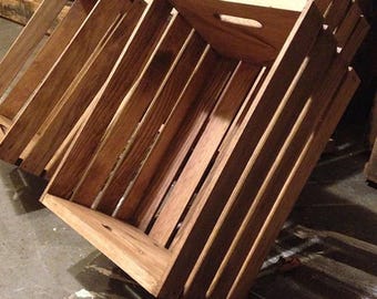 May include: A set of three wooden crates stacked on top of each other. The crates are made of natural wood and have a rustic look. They are perfect for storage or display.