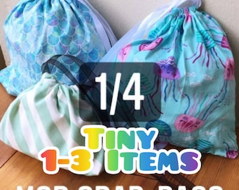May include: Three drawstring bags with different patterns. The bags are filled with small items. The bags are labeled "1/4 TINY 1-3 ITEMS MSD GRAB-BAGS MYSTERY BAG".