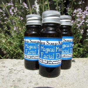 May include: Three small brown glass bottles with silver lids and blue labels. The labels read "Magical Mousse Facial Elixir" and "Soap Kitchen".