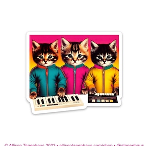 May include: Three cartoon cats wearing colorful jackets play a vintage keyboard. The cats are in a row, with the cat on the left wearing a teal jacket, the middle cat wearing a pink jacket, and the cat on the right wearing a yellow jacket.