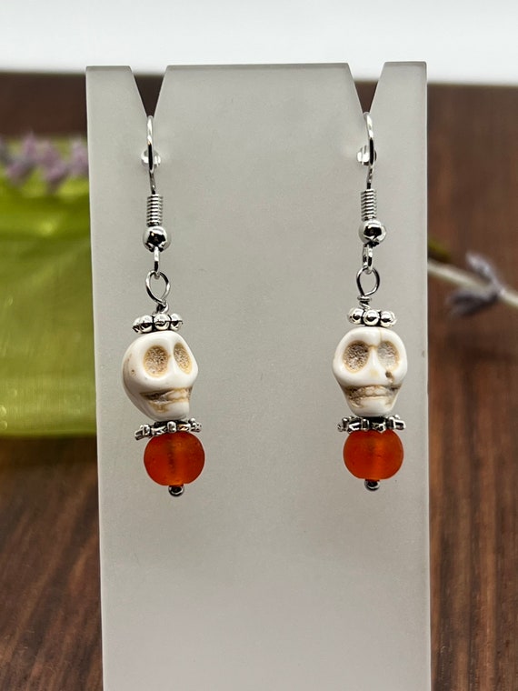 Skull earrings with recycled orange bead, white Howlite skull bead dangle earrings, white and orange earrings