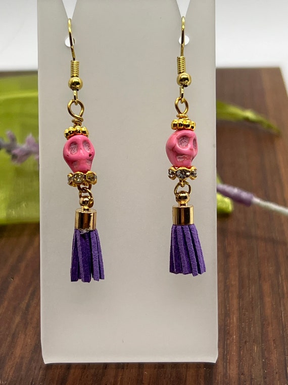 Sugar skull earrings, Halloween theme earrings, Cinco de Mayo skull, Pink skull with purple suede tassel and gold plate ear wires.