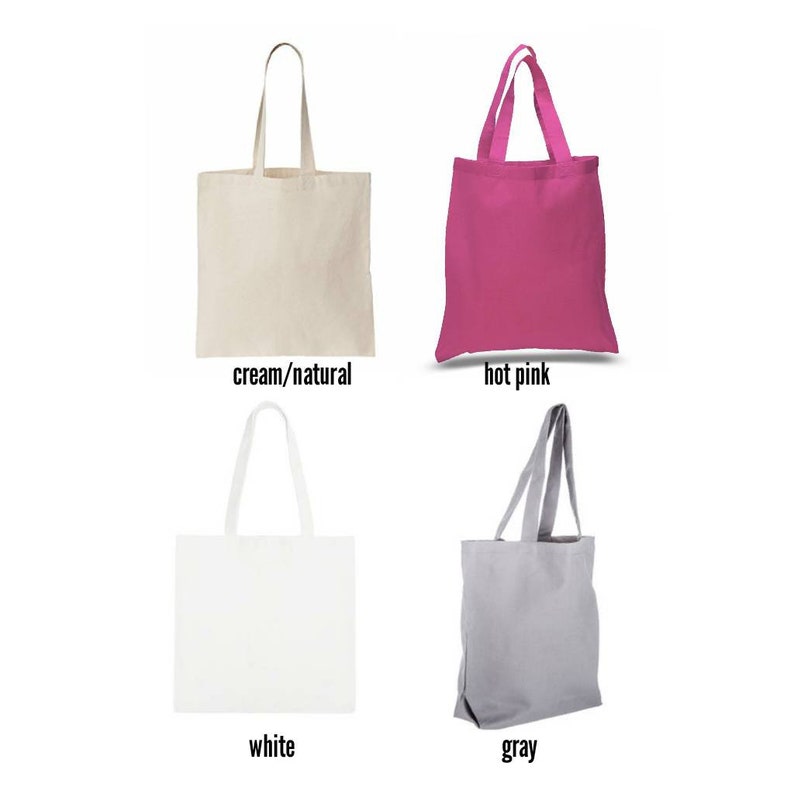 May include: Four tote bags in different colours: cream/natural, hot pink, white, and grey. The bags are made of canvas and have a simple design.