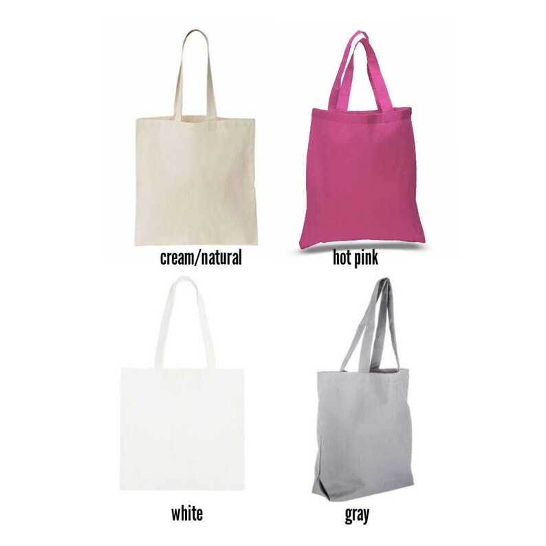 May include: Four tote bags in different colors: cream/natural, hot pink, white, and gray. The bags are made of canvas and have a simple design.