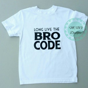 May include: White t-shirt with black text that reads "Long Live the Bro Code".