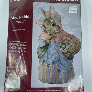 May include: A sealed Needle Treasures needlepoint kit featuring a design of Mrs. Rabbit, adapted from Beatrix Potter. The finished size is 8 x 14 inches. The kit includes canvas, yarn, floss, backing fabric, and instructions.