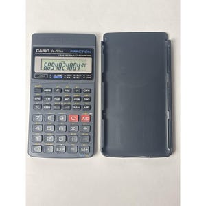 May include: A dark gray Casio fx-250HA scientific calculator with a protective cover. The calculator displays a numerical value on its screen. The keys are labeled with various mathematical functions and numbers.
