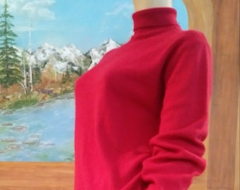May include: A bright red turtleneck sweater with long sleeves. The sweater is made of a soft, knit fabric.