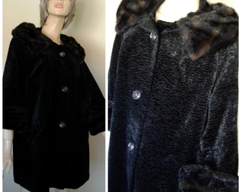 May include: A black faux fur coat with a brown faux fur collar and cuffs. The coat has a button closure and pockets.