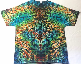 May include: A tie-dye t-shirt with a colorful, abstract pattern in shades of blue, green, orange, and red. The pattern is symmetrical and has a swirling, psychedelic look.