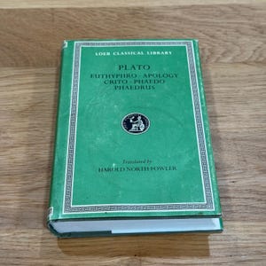 May include: A green hardcover book from the Loeb Classical Library featuring the title Plato, Euthyphro, Apology, Crito, Phaedo, Phaedrus, and the translator Harold North Fowler. The cover includes a circular logo and a white geometric border.