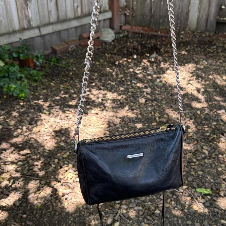 Bolso bandolera de piel negra estilo motero con 5 cremalleras de Rebecca Minkoff y herrajes plateados. imagen 4