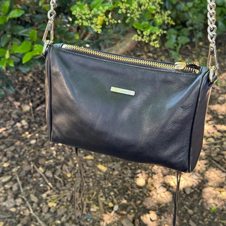 Bolso bandolera de piel negra estilo motero con 5 cremalleras de Rebecca Minkoff y herrajes plateados. imagen 1