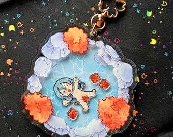 May include: A clear acrylic charm featuring a cartoon character floating in a blue pool surrounded by orange foliage. The charm has a gold-colored clasp and a flower-shaped connector. The background is black with colorful shapes.