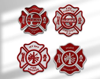 May include: Four embroidered patches in the shape of a Maltese cross, featuring red and white thread. Each patch displays fire department imagery including ladders, hydrants, and axes, with text reading Lykins, Grifith, Ivy Gap, and Feuer.