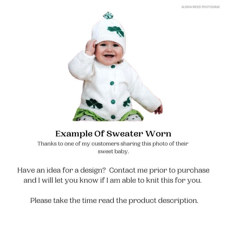 May include: A baby wearing a white knit sweater and matching hat with green shamrock accents. The sweater has green buttons and shamrock details. The baby is also wearing a green and white ruffled bottom.