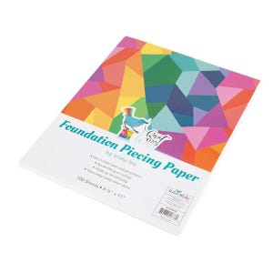 May include: A stack of white Foundation Piecing Paper sheets. The top sheet has the text "Foundation Piecing Paper" and a colorful geometric design. The paper measures 8.5" x 11" and is from Kristy Lea.