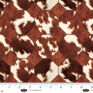May include: A patchwork design featuring brown and white cowhide-like patterns. The design is composed of octagonal shapes stitched together with a contrasting thread. The pattern is reminiscent of a rustic or Western aesthetic.