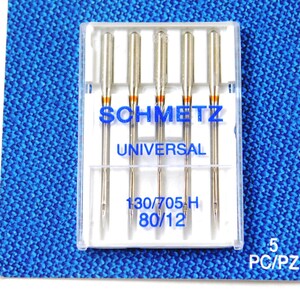 May include: A pack of five Schmetz Universal sewing machine needles in a clear plastic case. The needles are size 130/705H and 80/12.